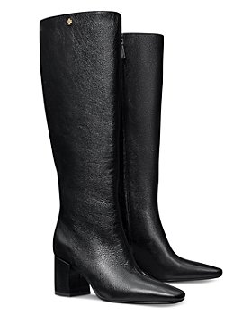 black trousers wearing black leather knee length riding boots - Playground