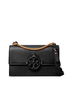 the miller affect carrying a tory burch cognac mini crossbody from