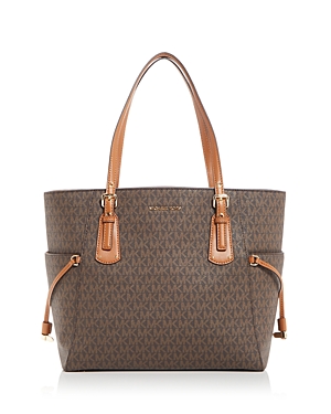 Shop Michael Michael Kors Signature Voyager East West Tote In Brown