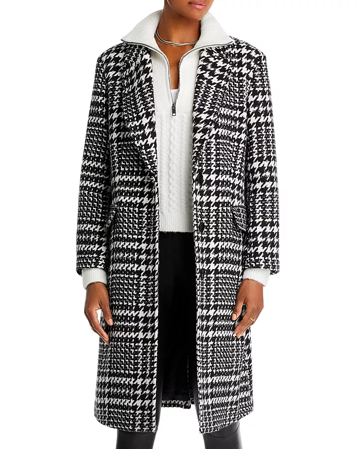 woman wearing a black and white pattern style winter coat