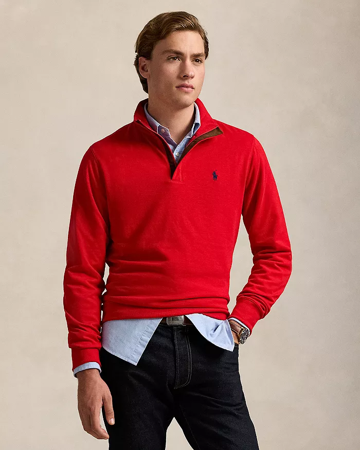 A man wearing a red quarter zip pullover
