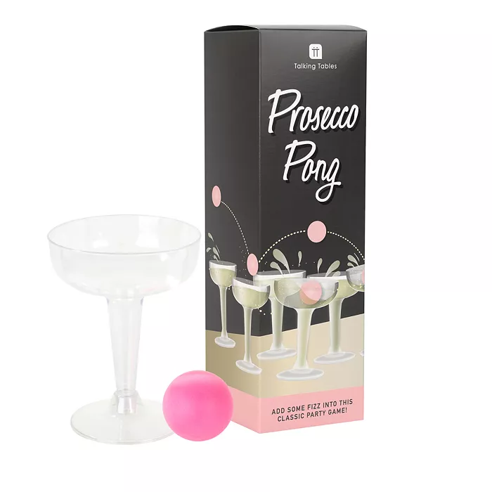 A black box next to a clear glass and a pink ball
