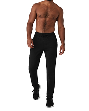 Shop Alo Yoga Conquer Pulse Tapered Drawstring Pants In Black