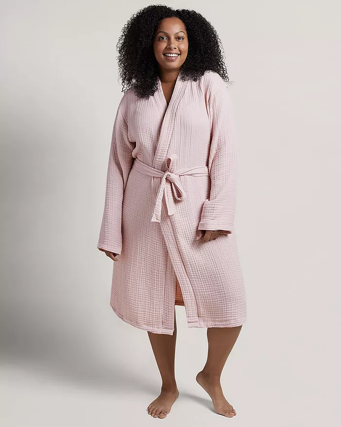 A woman wearing a pink robe