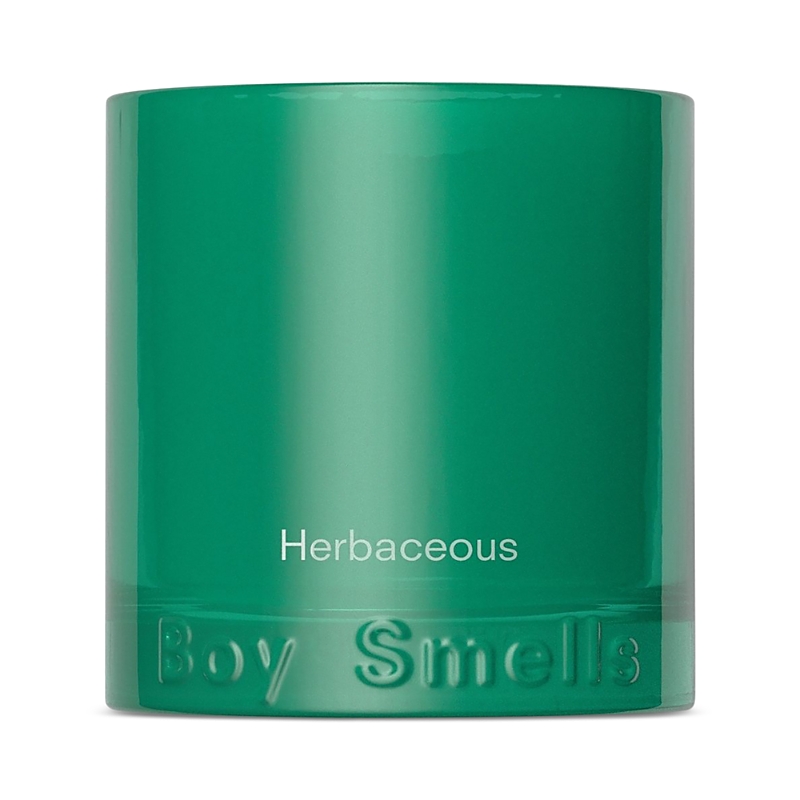 Boy Smells Herbaceous Candle In Green