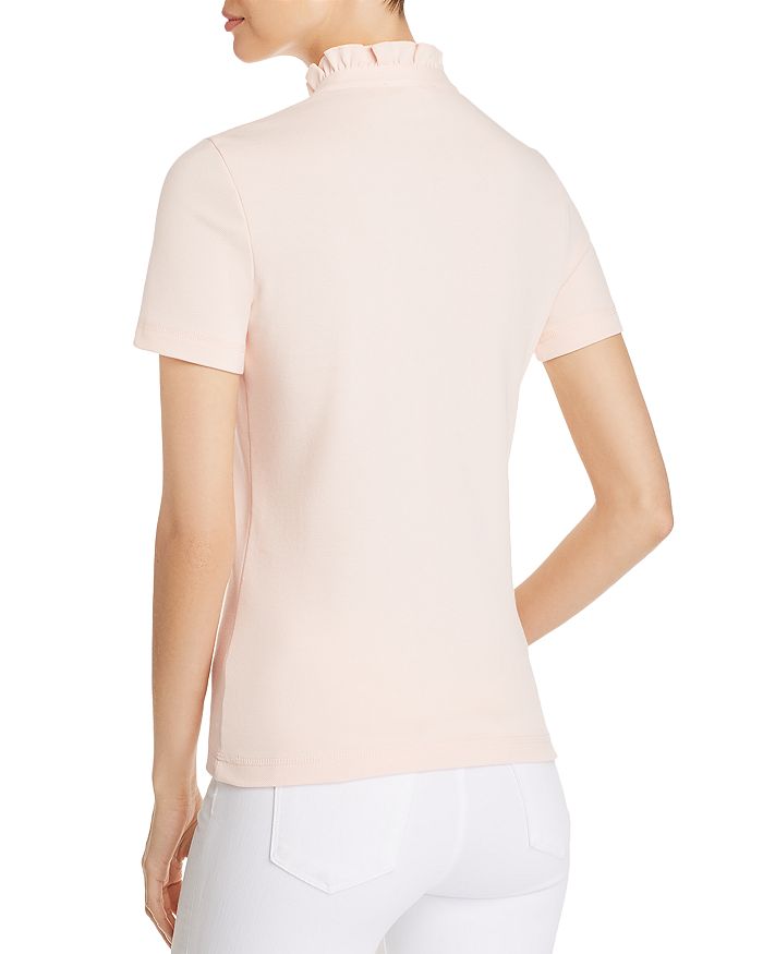 Shop Tory Burch Emily Ruffle Polo Shirt In Ballet Pink