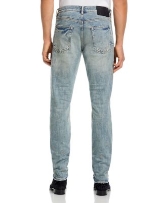 Worn Slashed Paint Jeans in Light Indigo