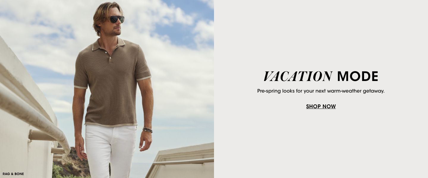 1 photo, of a male model with blue skies behind him, in a Rag and Bone brown polo shirt, white jeans, and sunglasses.