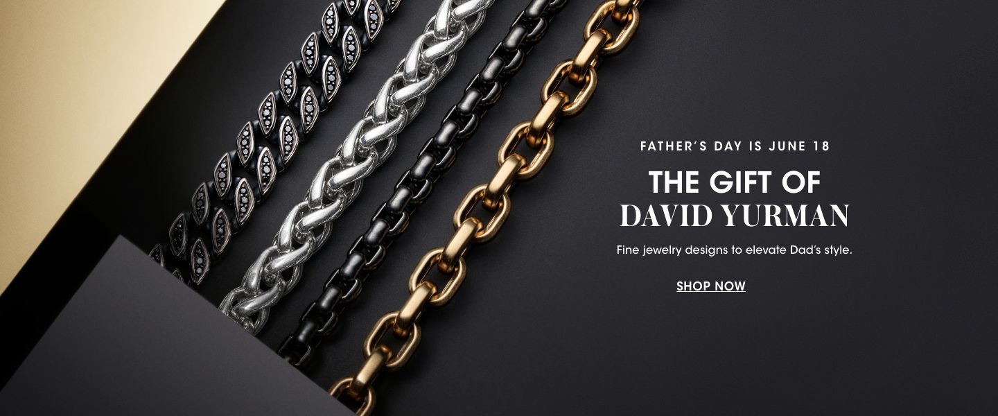 1 photo of four David Yurman bracelets on a black surface. From left, a double strand chain with black diamonds, a sterling silver chain link, a black boxed chain, and a gold chain link.