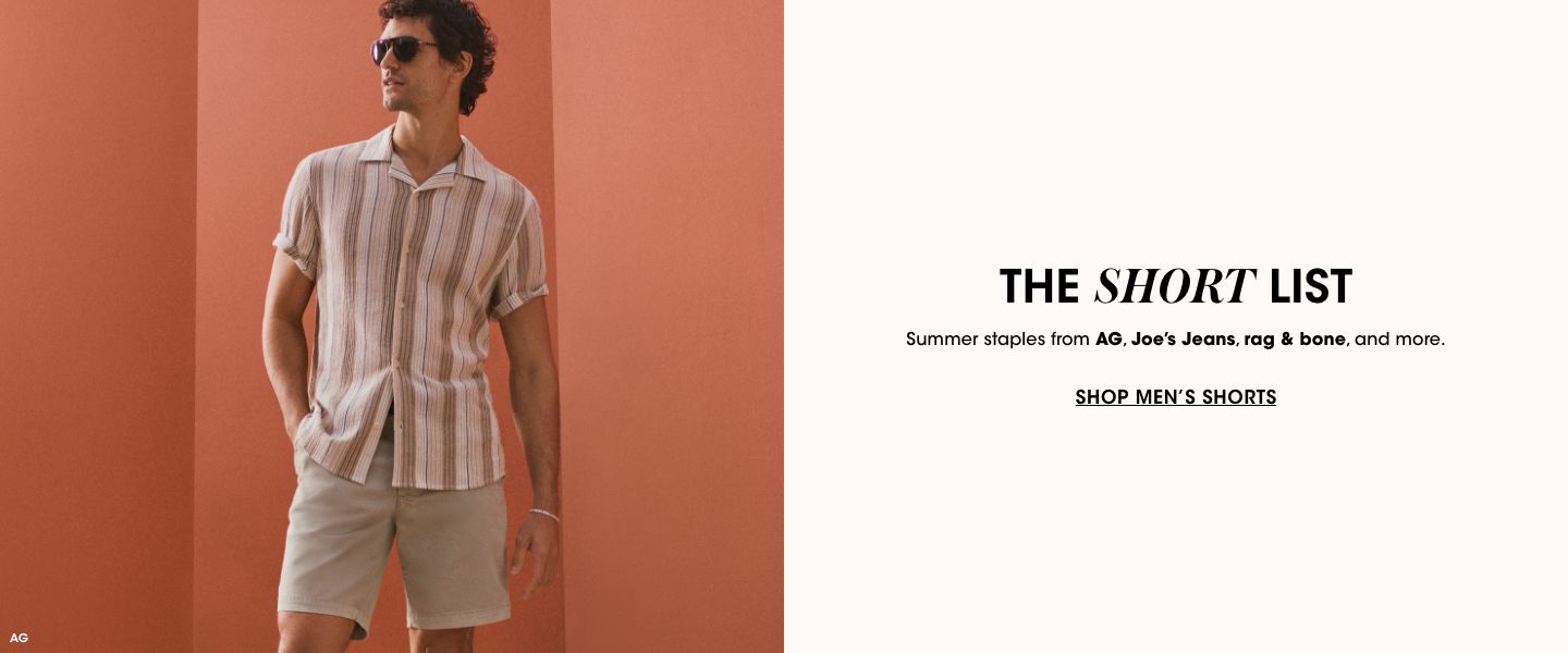 1 photo, of a male model in a brown and white striped short sleeve button down, light brown shorts, and sunglasses. He stands in front of a dark orange background and looks off to the side.