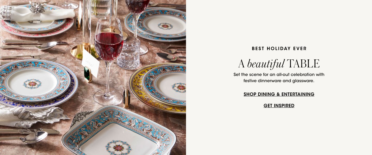 1 photo, of a festively decorated dining table, with intricately designed plates and chargers, crystal stemware with red wine, and silverware and napkin rings.