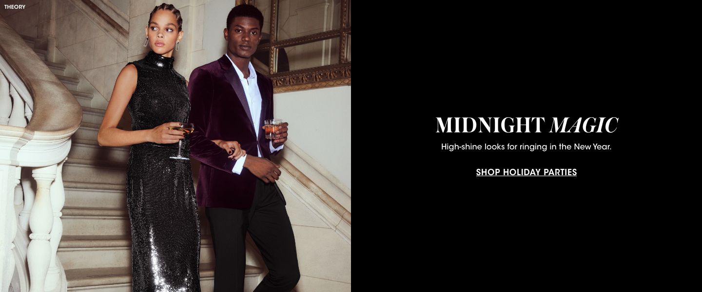 1 photo, of a female model descending a marble staircase in a long sparkling halter top black dress, arm in arm with a male model in a deep burgundy velvet suit, each with a drink in their hand.