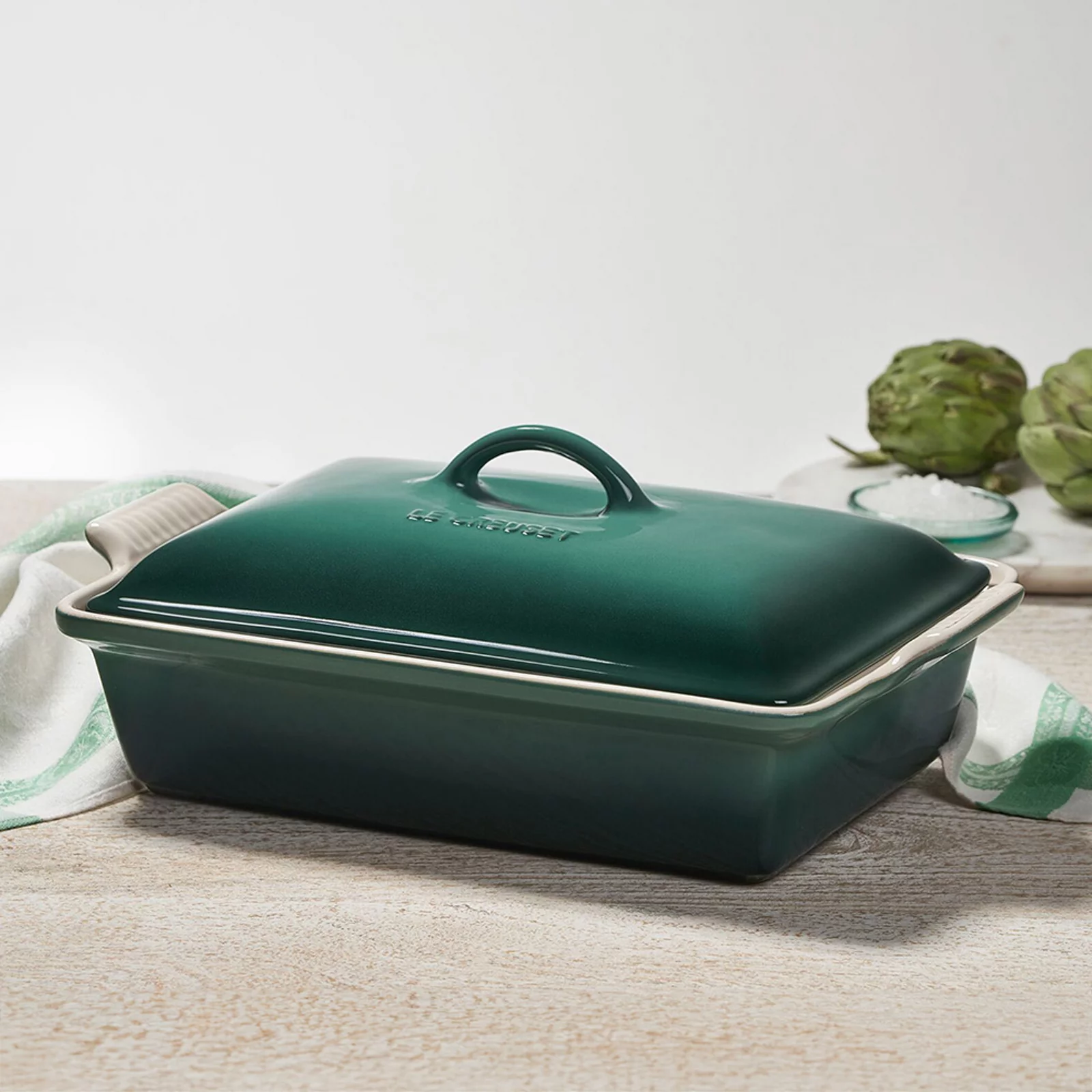 1 photo of dark green Le Creuset ceramic caserole pan with lid.