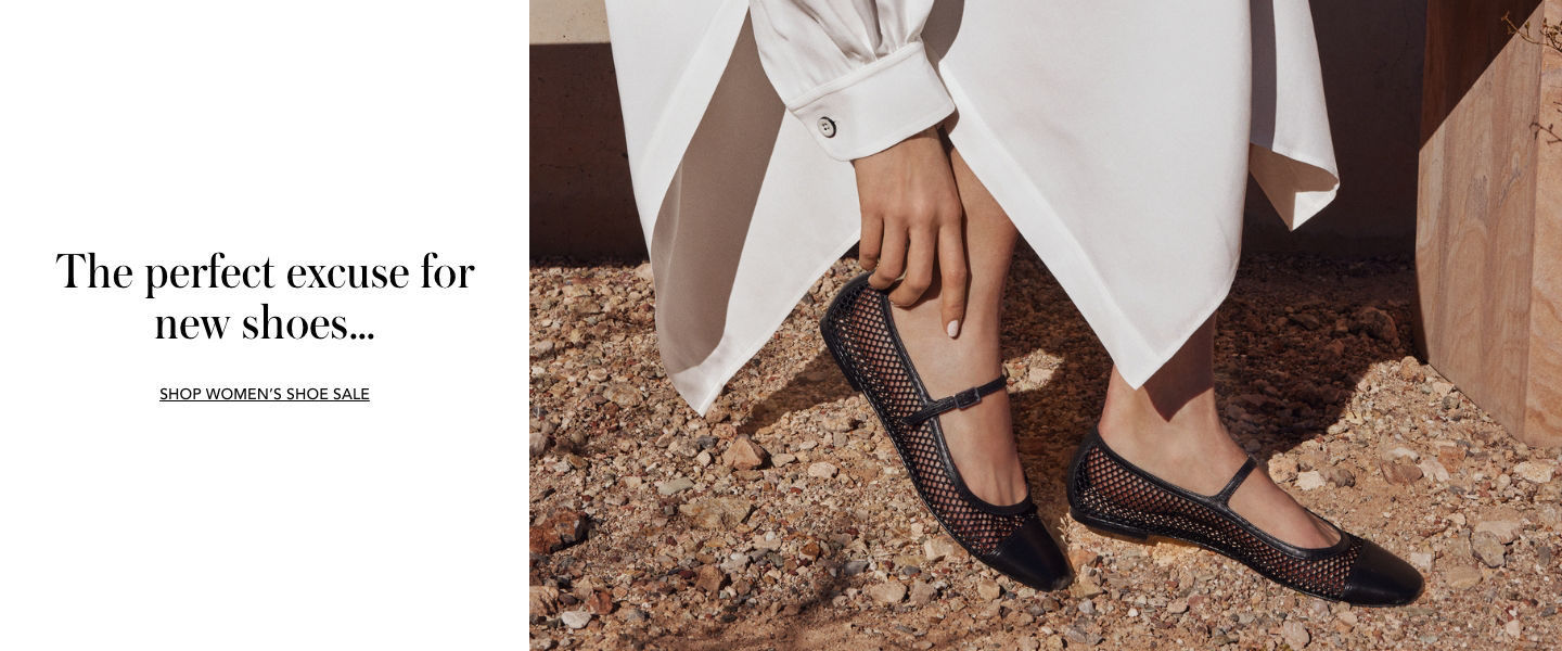 1 photo of close up of female model wearing black ballet flat shoes of mesh material, while posing in a desert background.