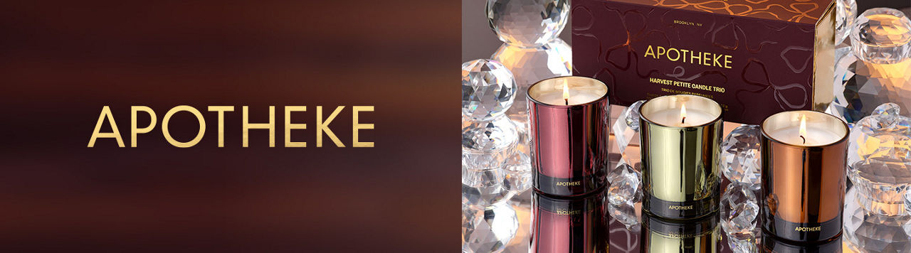 Apotheke. 3 lit Apotheke candles surrounded by crystal figurines.