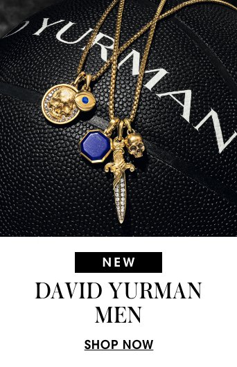 1 photo, of various David Yurman mens gold amulets and pendants hanging from curb chains, laying atop a black basketball with a white David Yurman logo on it.