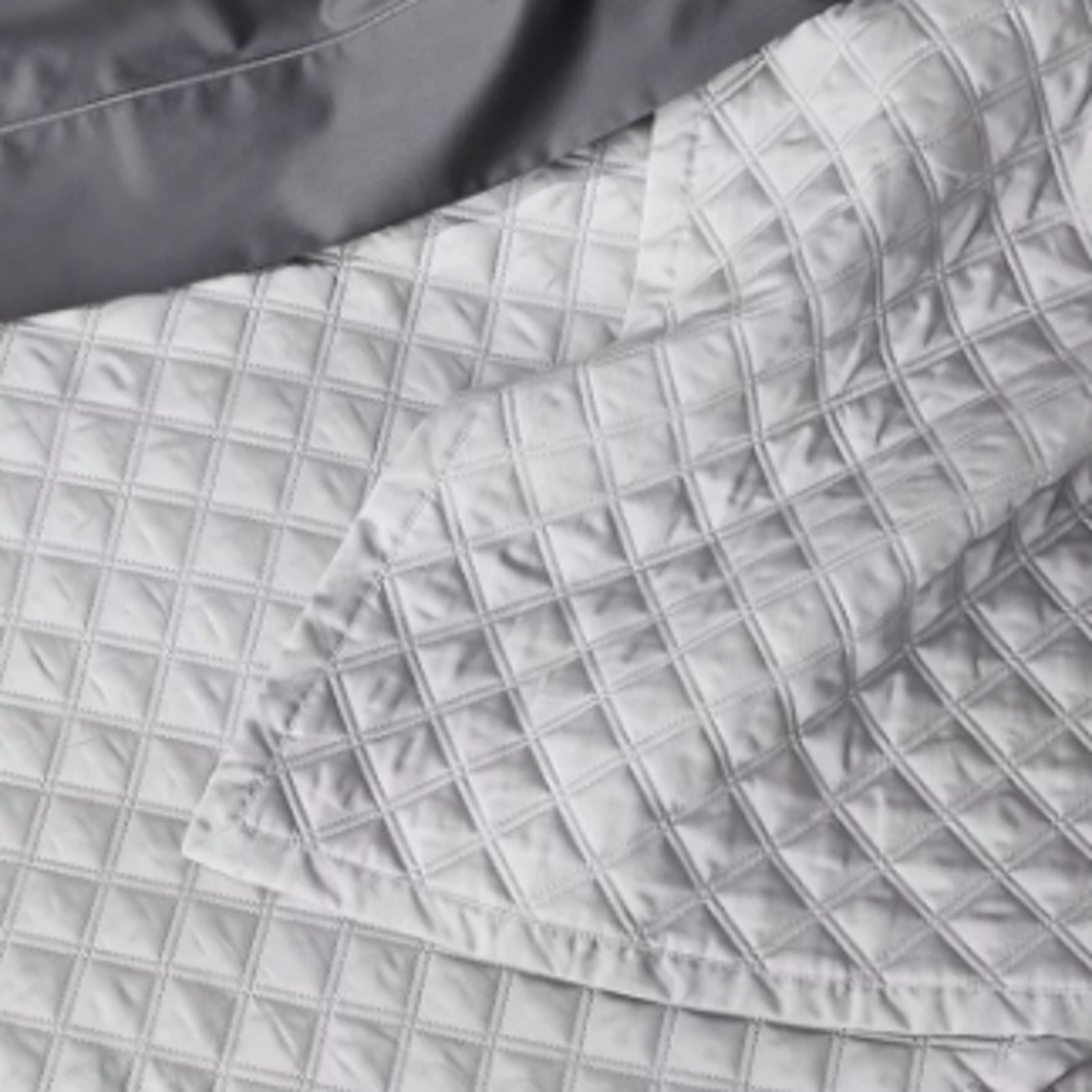 1 photo of white Hudson Park quilt and dark gray Hudson Park satin coverlet.
