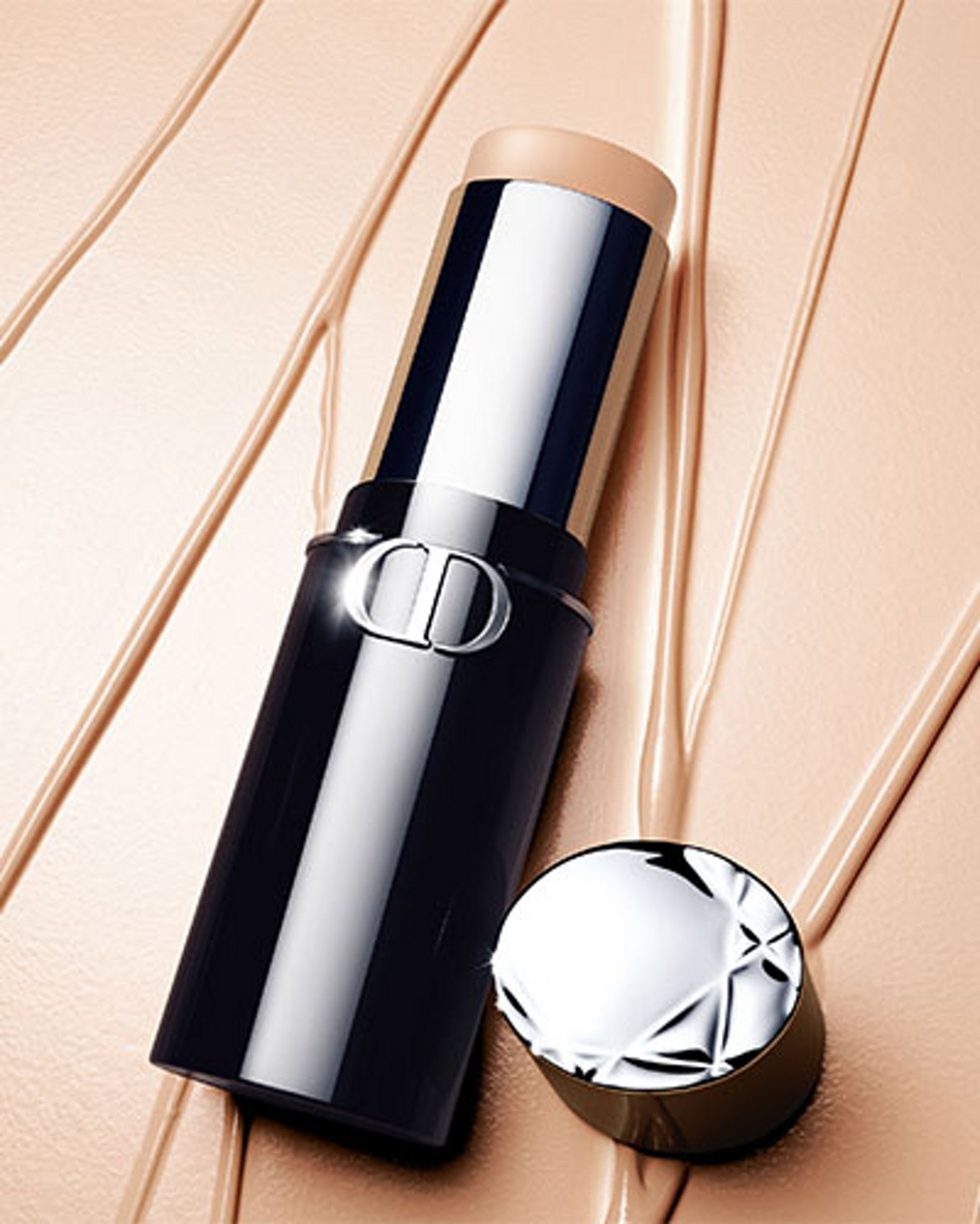 1 photo of Dior Forever Skin Perfect Stick resting on decorative background to showcase smooth texture of concealer makeup.
