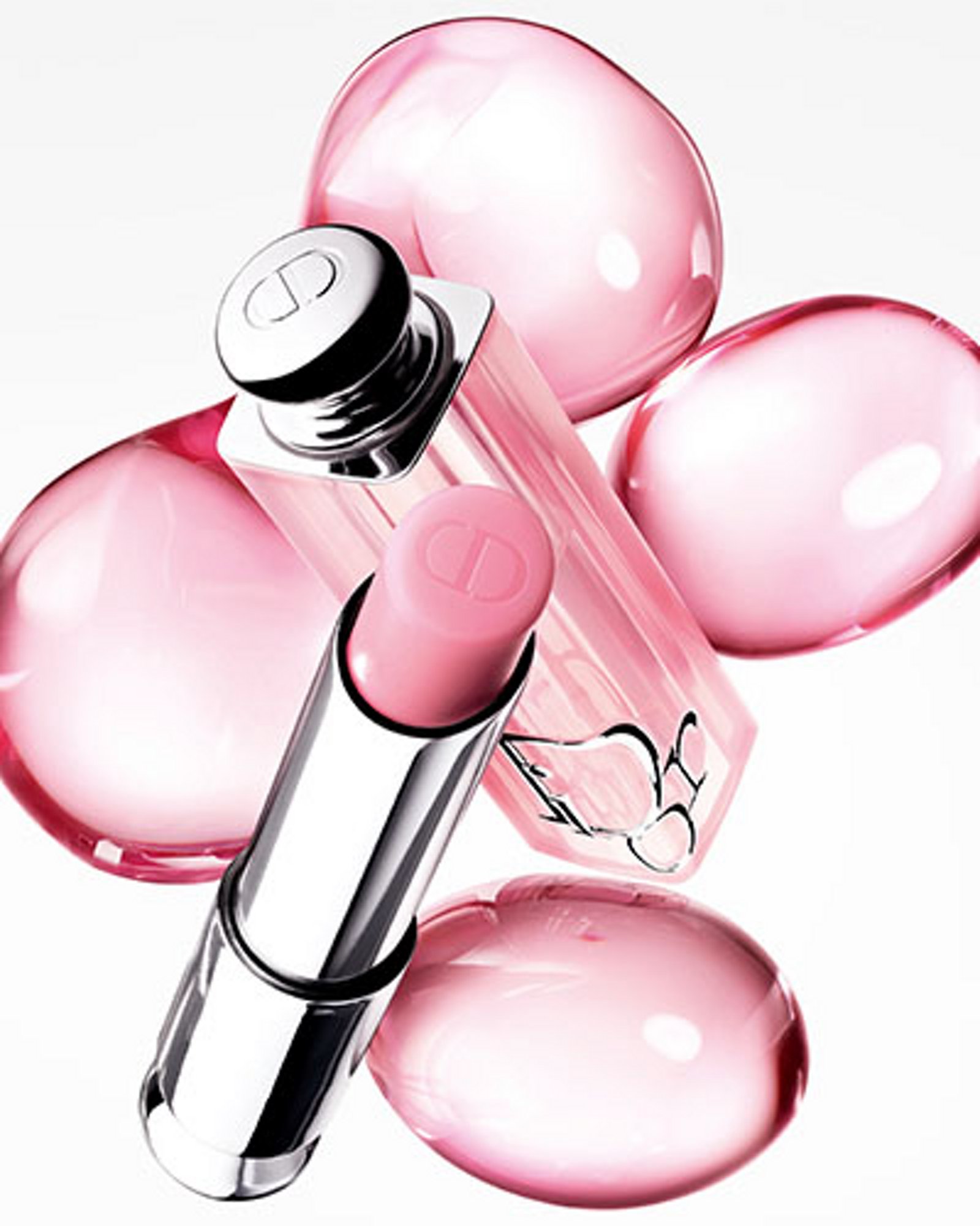 1 photo of Dior Addict Lip Glow set against a background of pink glass bubbles.