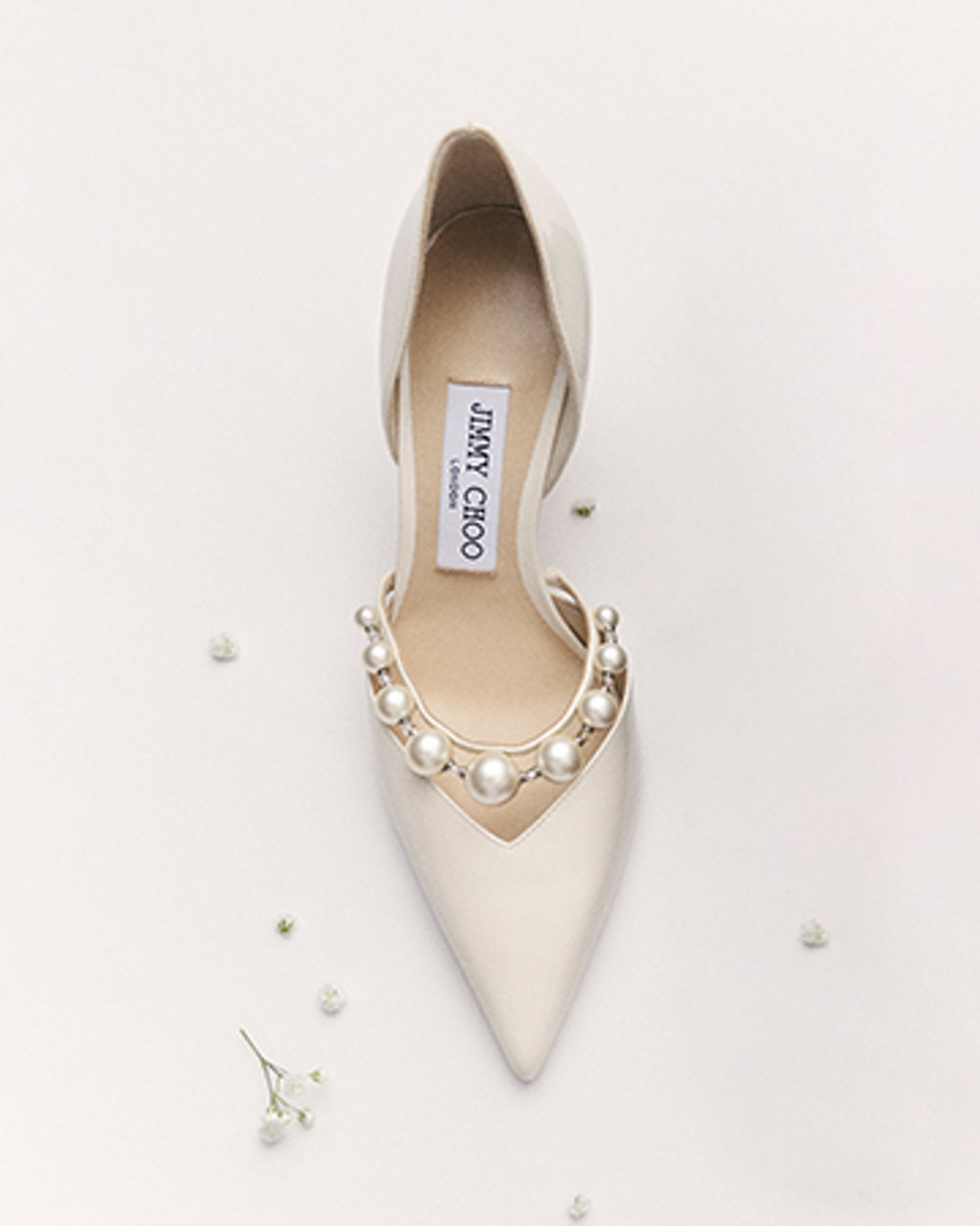 1 photo of Jimmy Choo white leather pump with pearl accents.