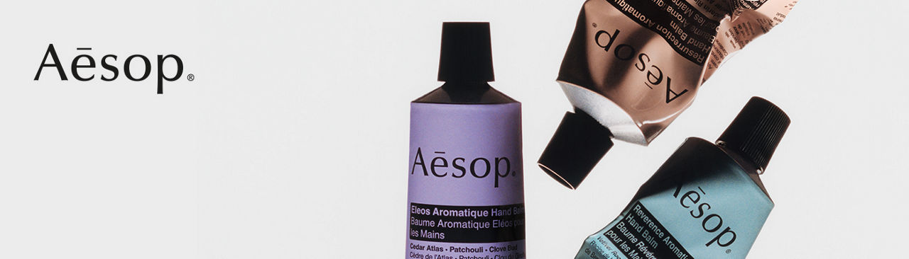 1 photo, a closeup of 3 tubes of Aesop hand balm in purple, brown and light blue, 2 tubes squeezed in the middle.