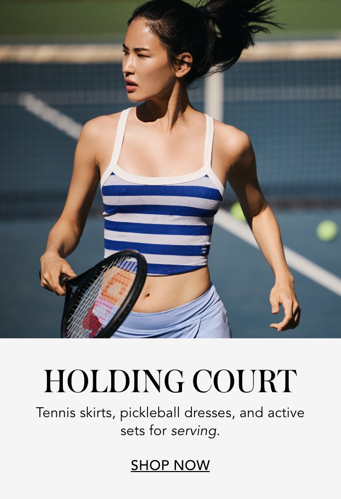 1 photo of woman on a tennis court holding a tennis racket, running in a blue striped tank top and athletic shorts. 