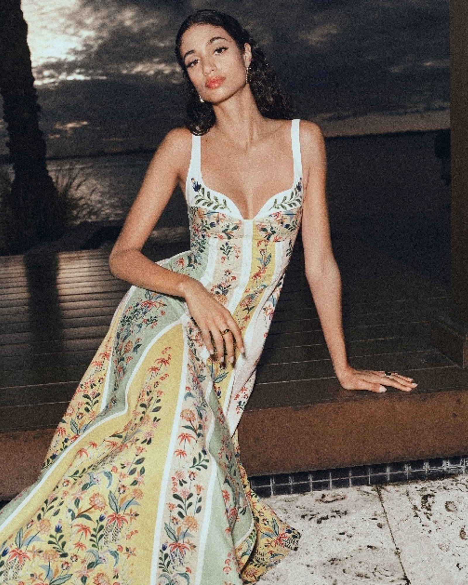 1 photo of female model in long dress with straps and floral pattern.