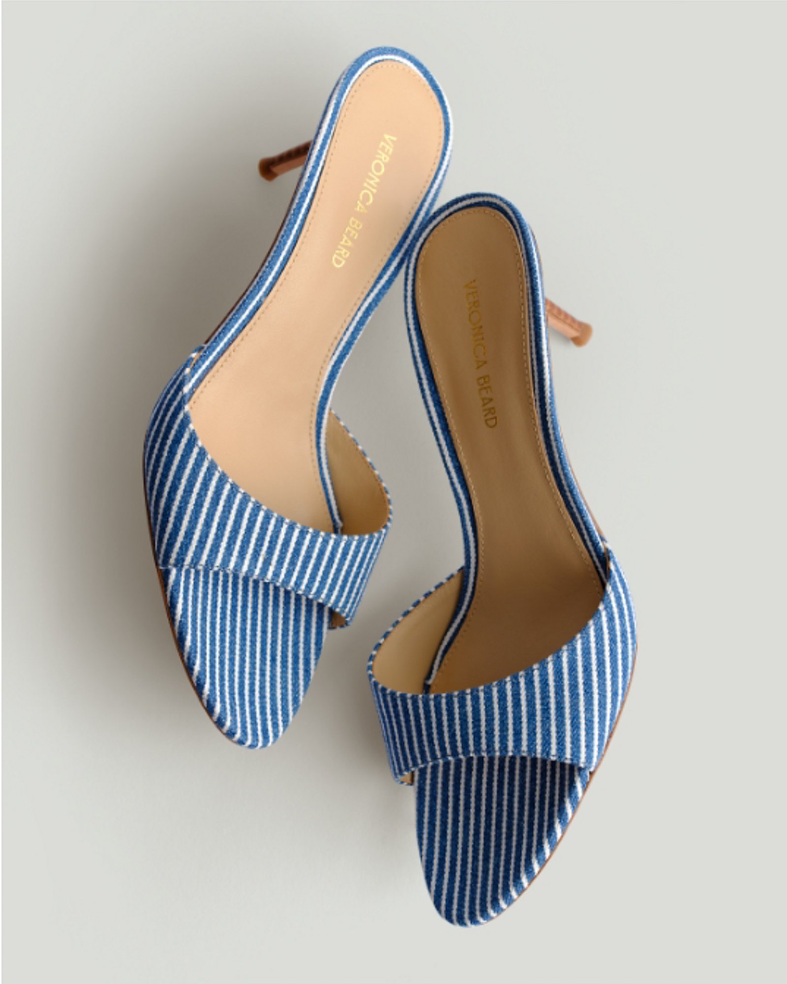 A pair of blue and white striped high heel sandals.