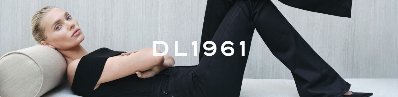 D. L. 1961. A woman lying on a chaise lounge in a black, off the shoulder D. L. 1961 top and pants.