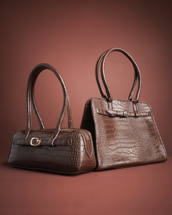 1 brown leather shoulder bag and 1 brown leather top handle bag.