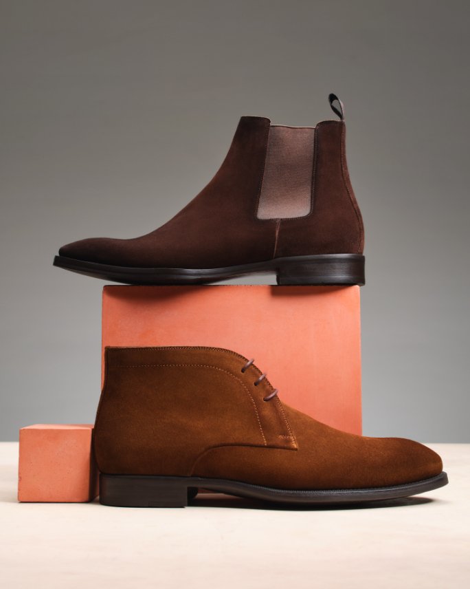 1 brown boot and 1 brown loafer.