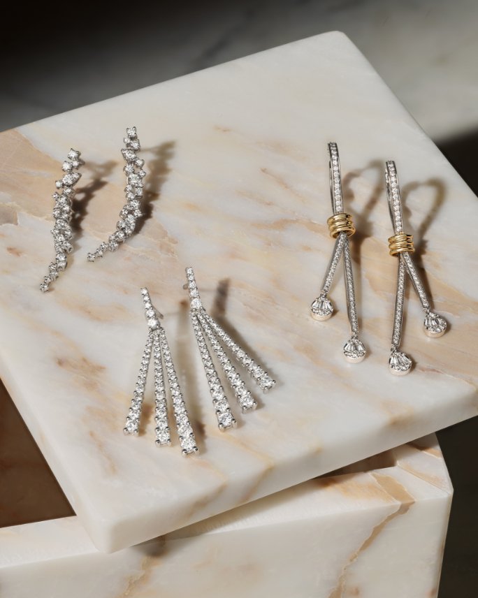 Three pairs of drop statement earrings in sterling silver with white diamonds, 3rd pair has accents of yellow gold.
