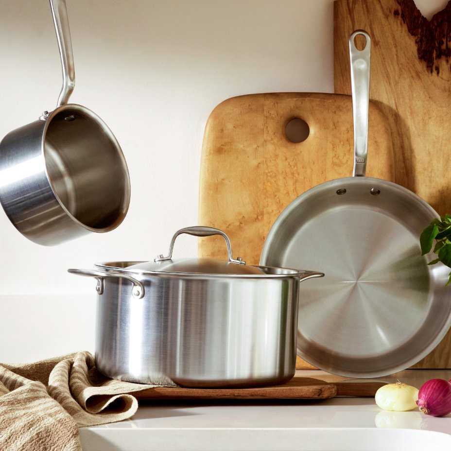 Three stainless steel cookware items, 1st sauce pot without lid, 2nd stock pot with lid, and 3rd frying pan without lid.