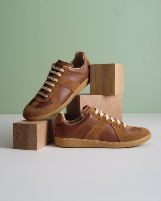 Photo of a pair of mens brown leather and suede sneakers.
