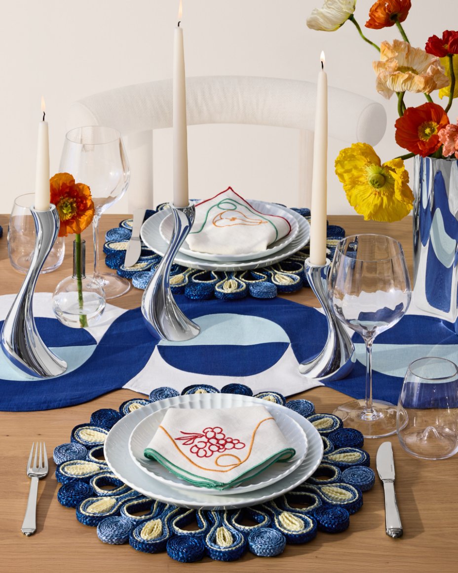 A blue, white and yellow Georg Jensen table setting, including Cobra candlesticks.