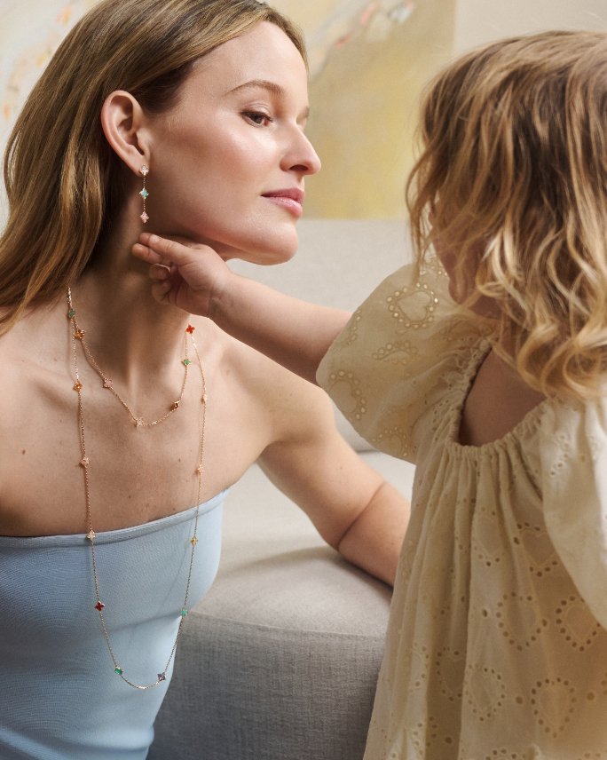 A young girl touching her mothers drop earring. Shop featured shops, mothers day gifts.