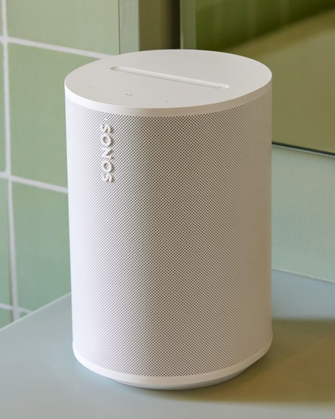 A white Sonos tabletop speaker on a counter. Dorm room essentials, tech.