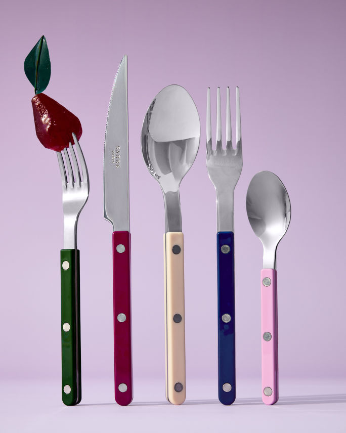 A set of Sabre Paris silverware with colorful riveted handles. Shop Sabre Paris.