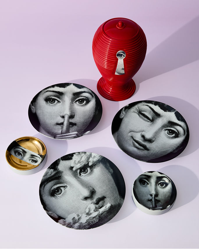 Fornasetti appetizer plates with an illustration of Lina Cavalieris face. Shop Fornasetti.