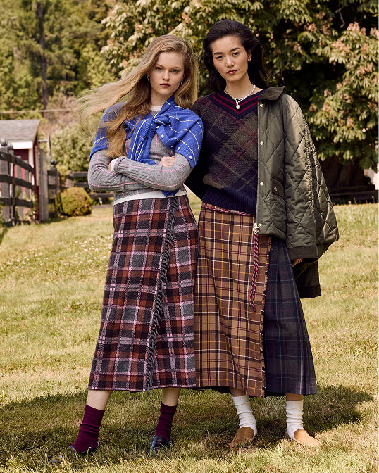 2 women in plaid skirts and sweaters. Shop country prints.