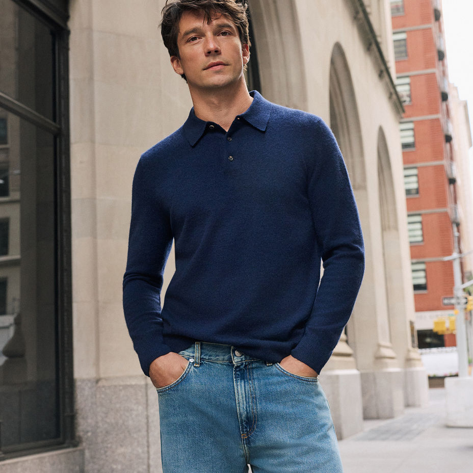 A man in a dark blue cashmere long sleeve polo. The cashmere guide, the mens store at bloomingdales.