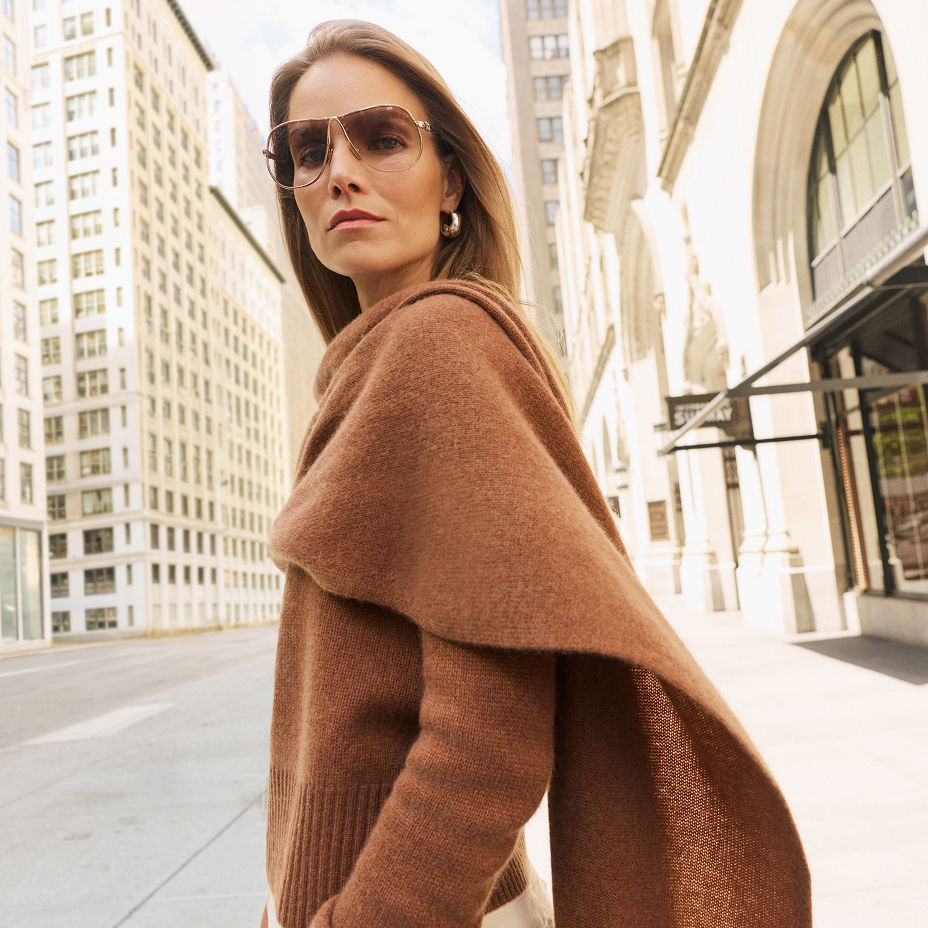 A woman in a brown cashmere sweater with scarf. The cashmere guide, C by Bloomingdales Cashmere.$$111NEWCashGD