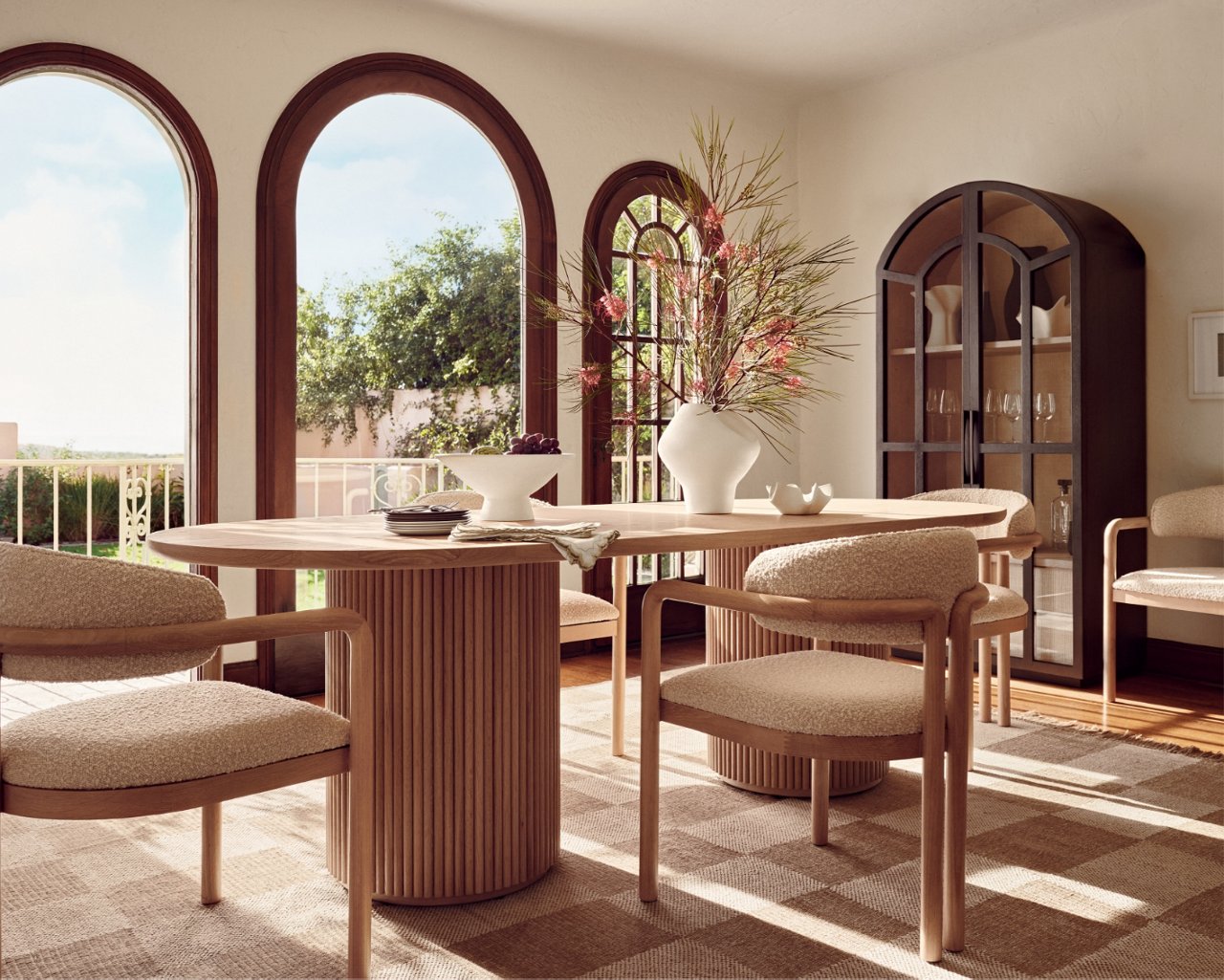 A sun bathed dining room with West Coast influenced sculptural table & chairs. Shop West Coast living.