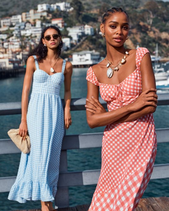 2 women in long summery gingham dresses.