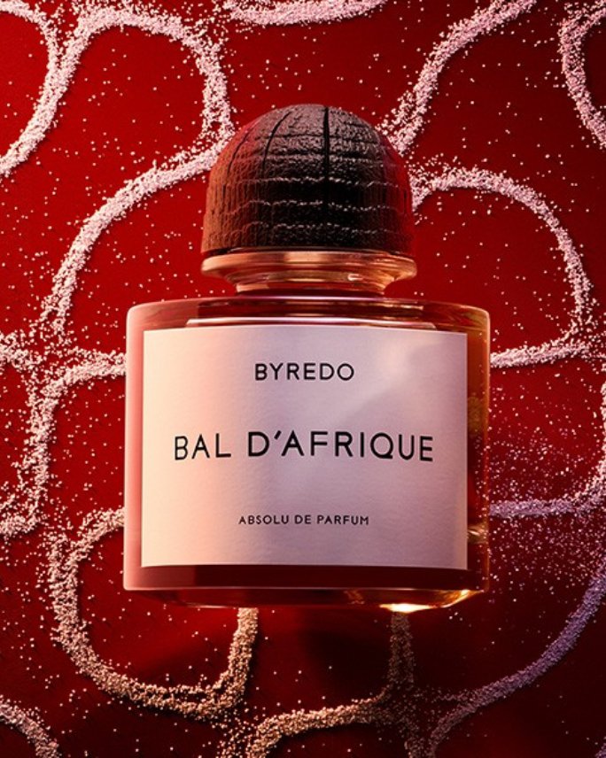 A red bottle of Byredo Bal d Afrique Absolue de Parfum. Shop Byredo.