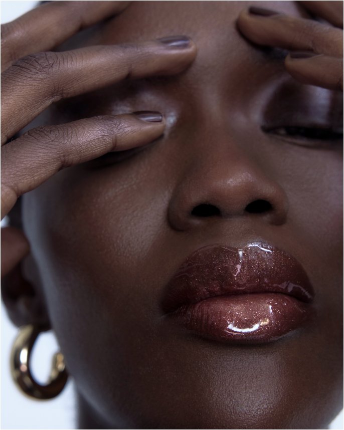 Closeup of a womans face with glossy red lips. Explore the guides, makeup.