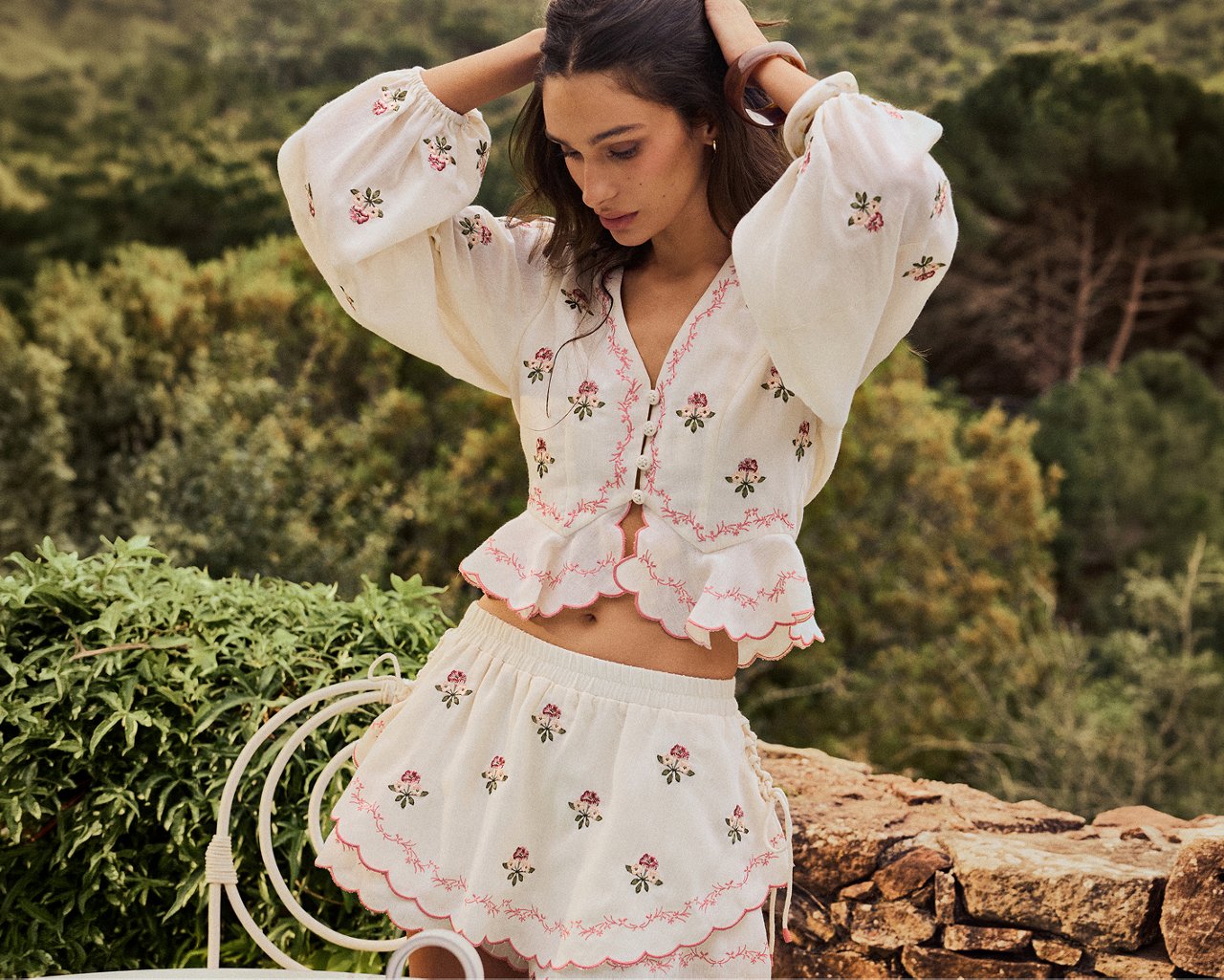 A woman in a long sleeve top with embroidery & matching skirt. New from Aqua. Aqua by Agua Bendita.