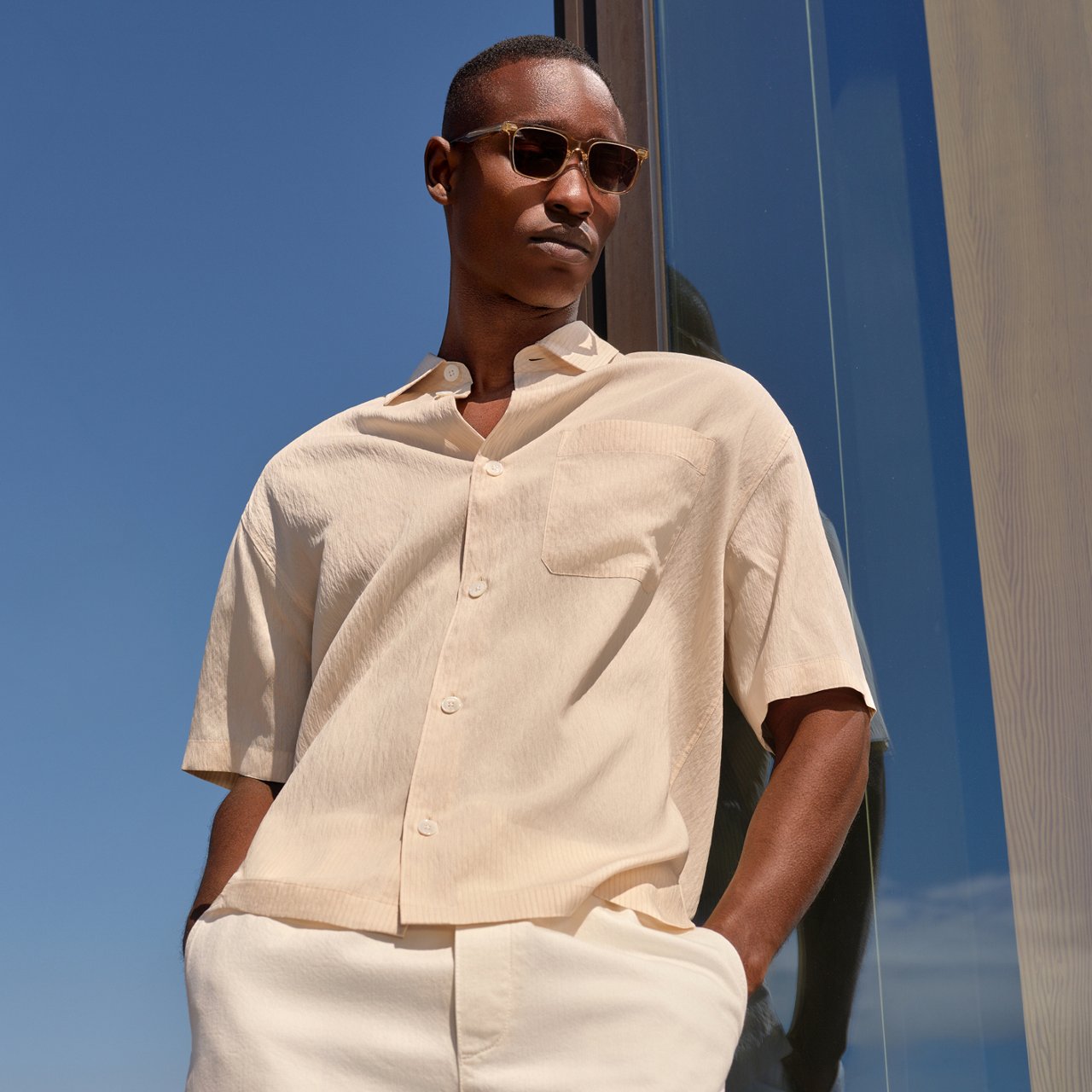 A man in a beige short sleeve button down. Top fathers day gifts, button downs.