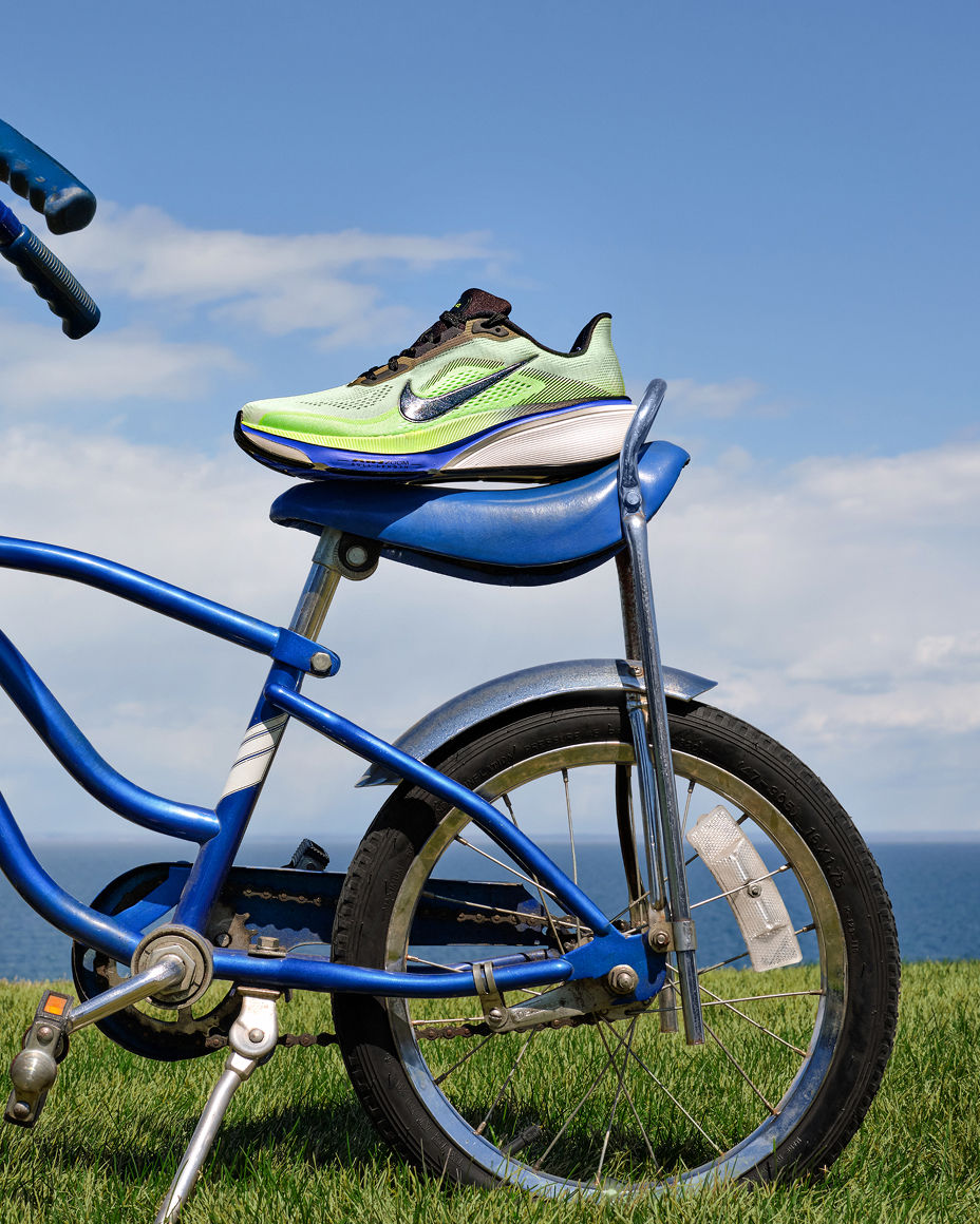 A retro bike with a green with blue piping Nike sneaker balanced on the seat. Fathers Day gifts, our best gifts.