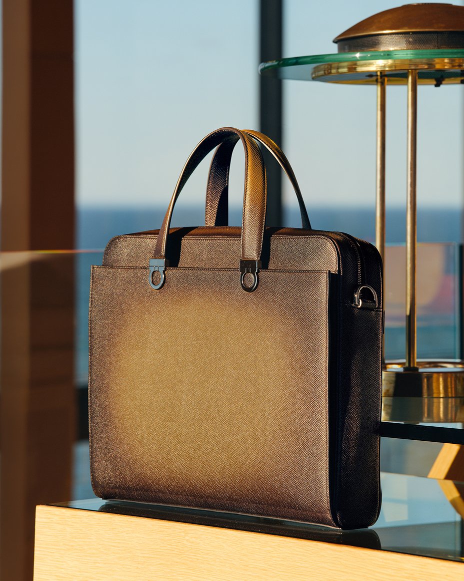 A brown leather briefcase on a counter. Fathers Day gifts, luxe gifts.